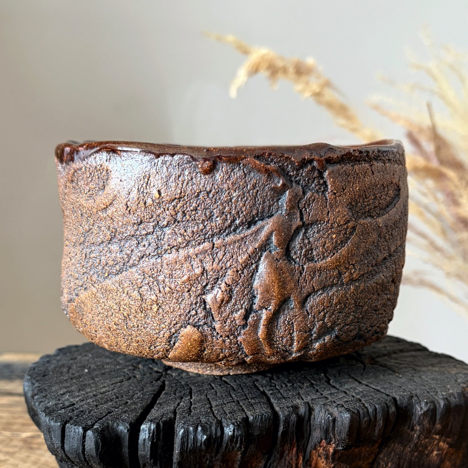 Side detail of handmade stoneware bowl with raised organic texture