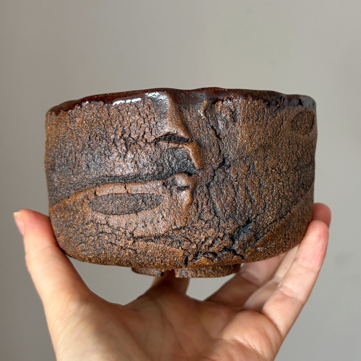 Handcrafted ceramic bowl with sculpted surface and earthy brown finish