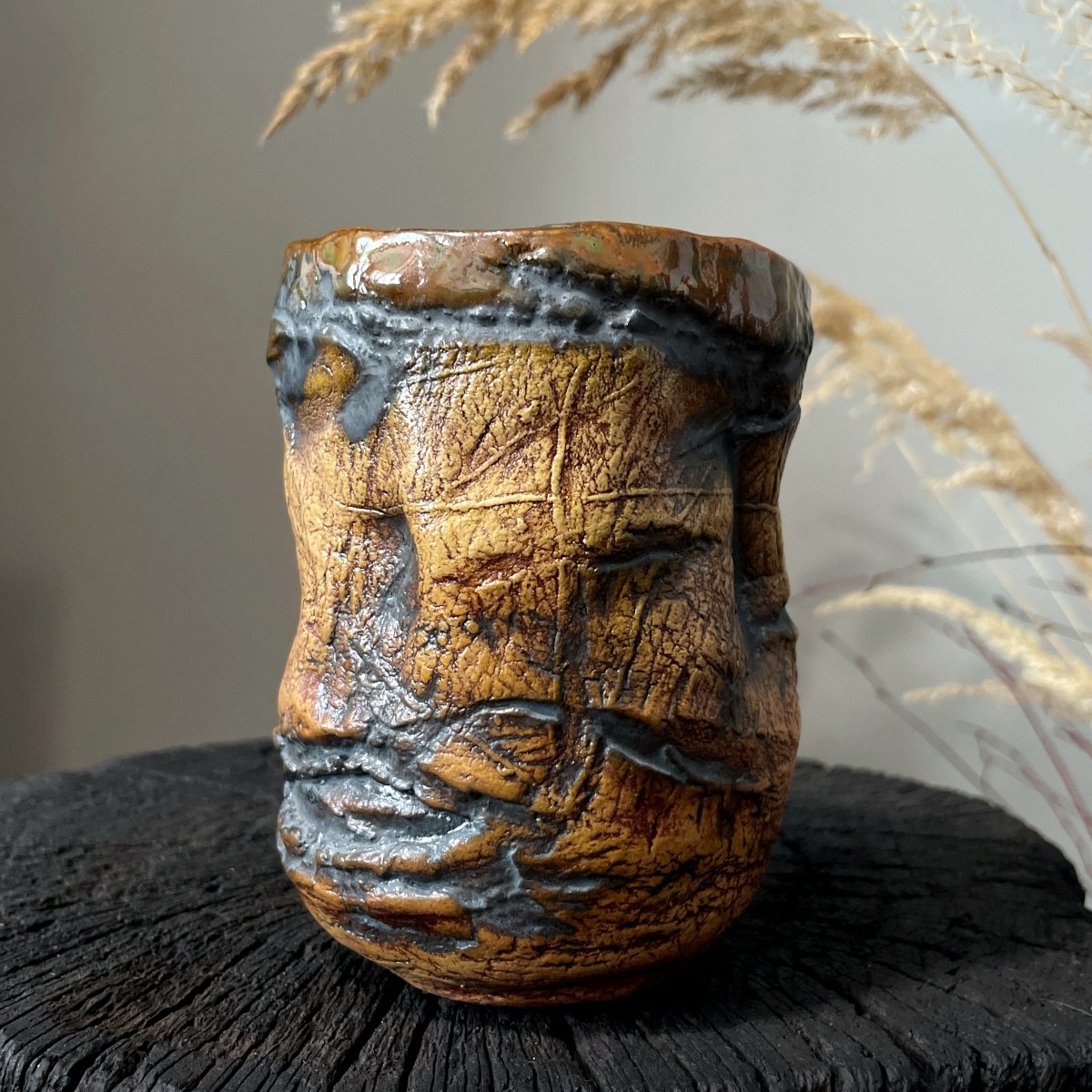 Handcrafted pottery tea cup with organic textured design