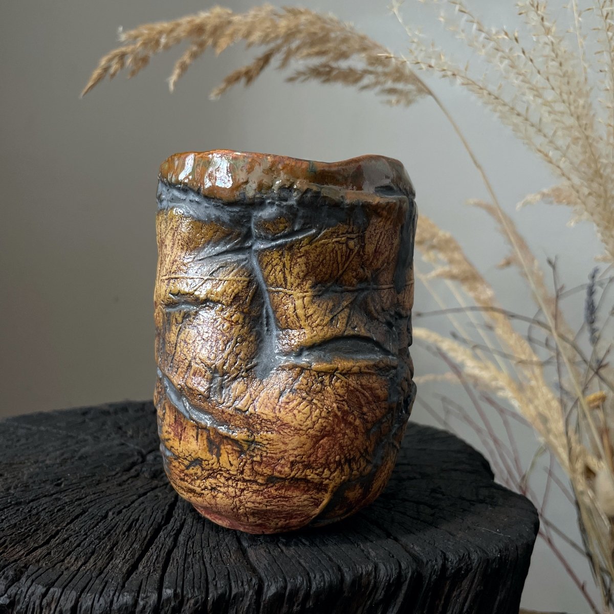 Front view of stoneware yunomi tea cup in brown glaze