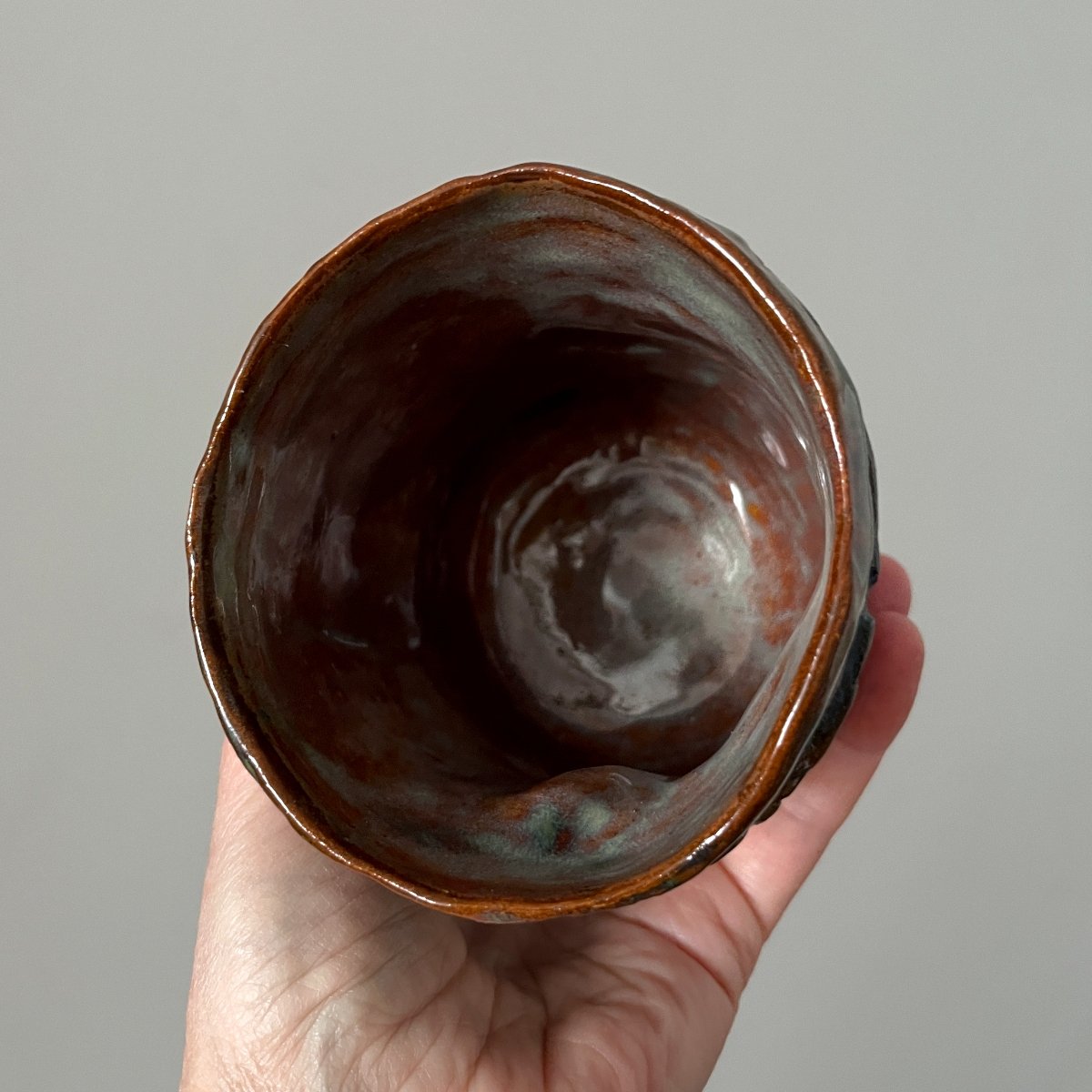 Top view of handmade ceramic yunomi tea cup with glazed interior