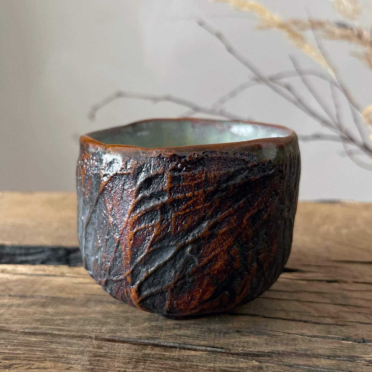 Stoneware yunomi tea cup with glazed interior and textured exterior