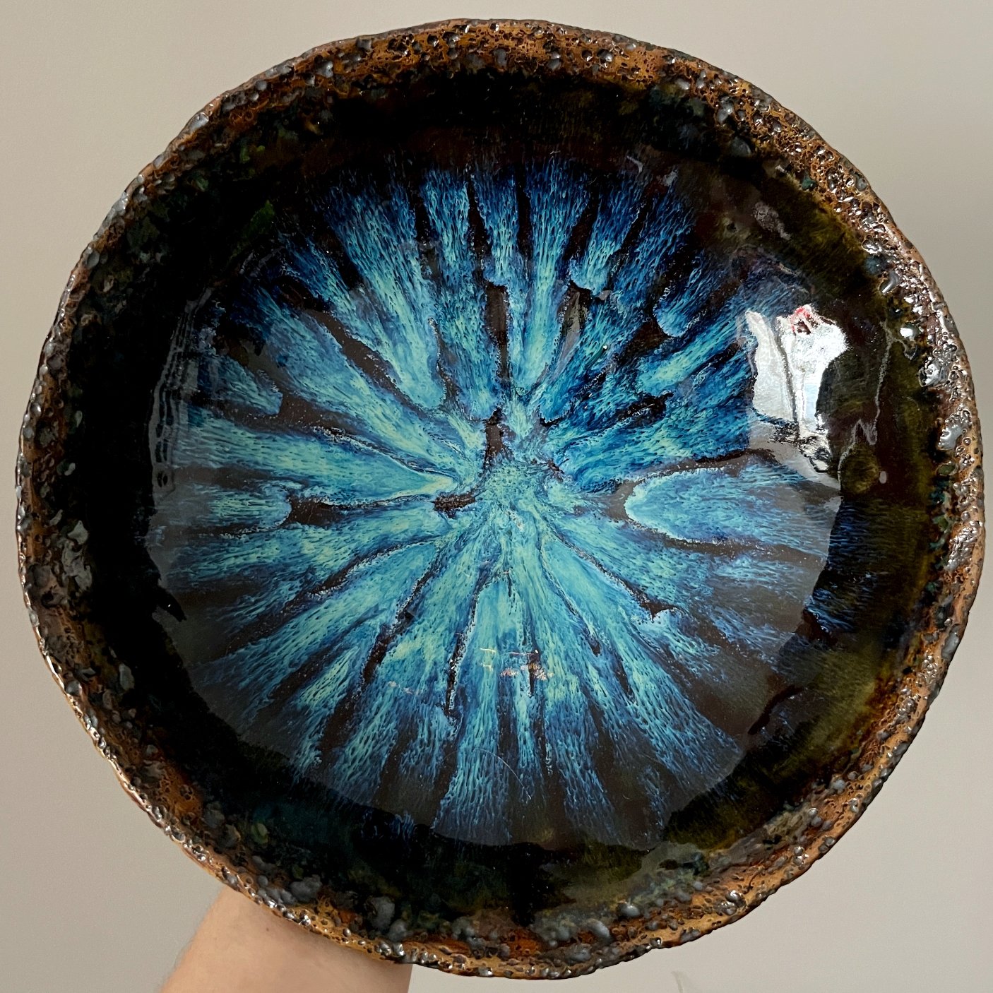 Handmade ceramic serving bowl with blue crystalline glaze interior