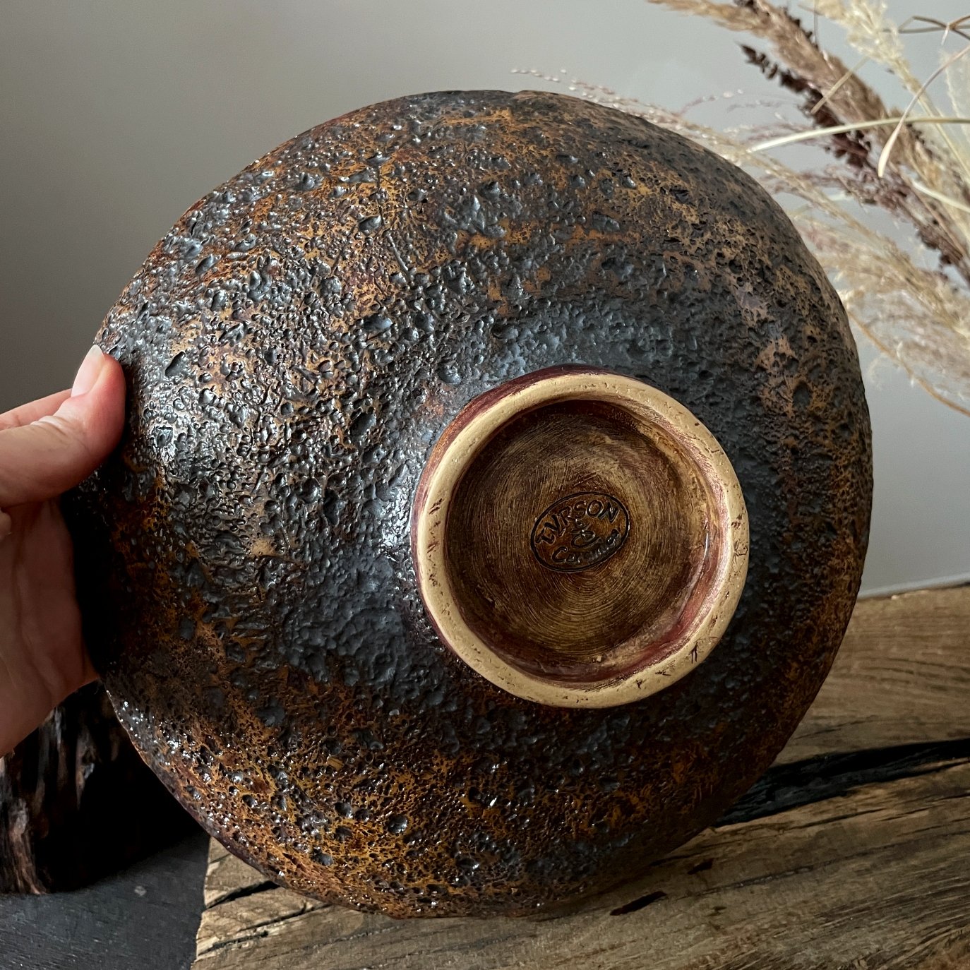 Bottom of handmade ceramic serving bowl with signed pottery foot