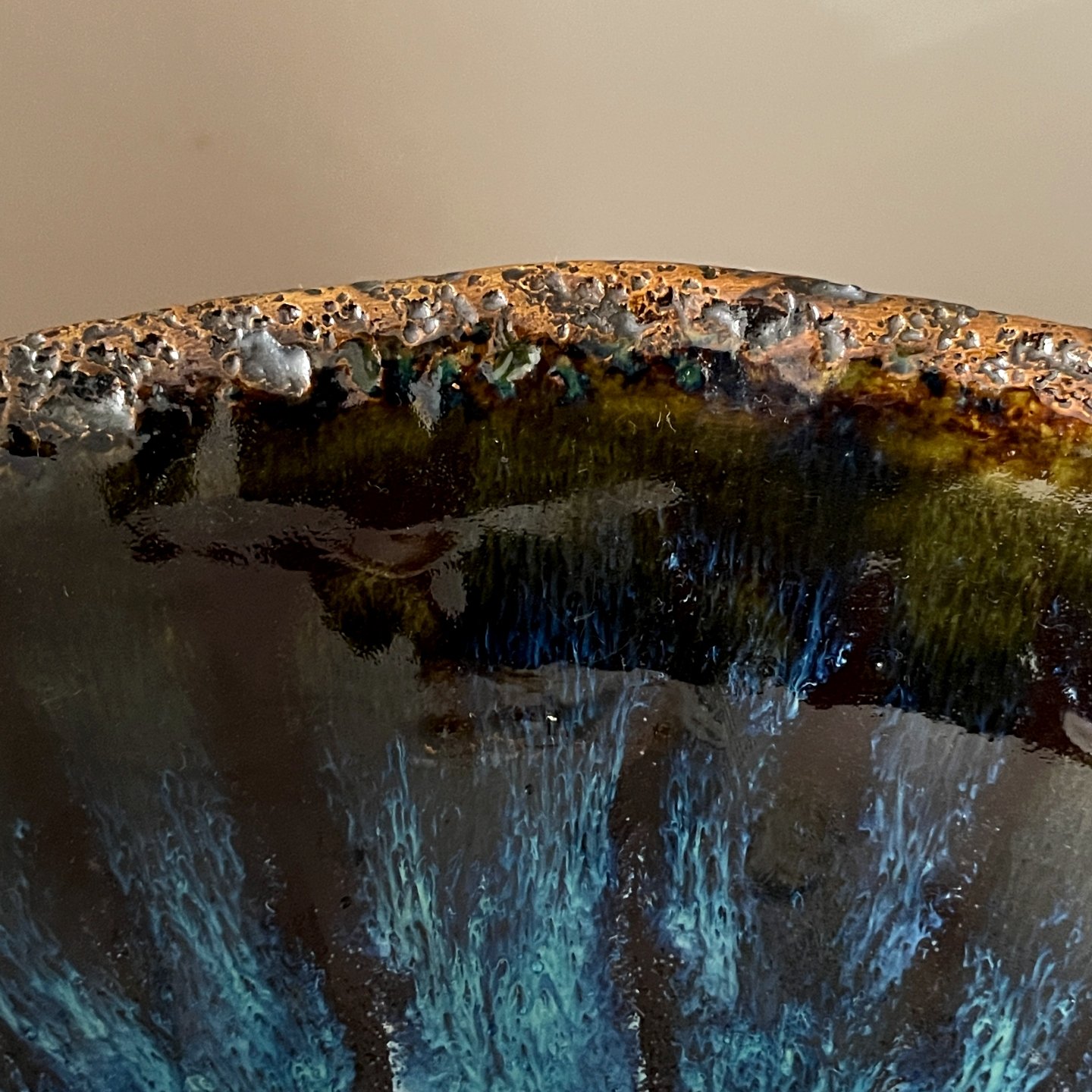 Handmade ceramic serving bowl with textured rim and blue crystal glaze