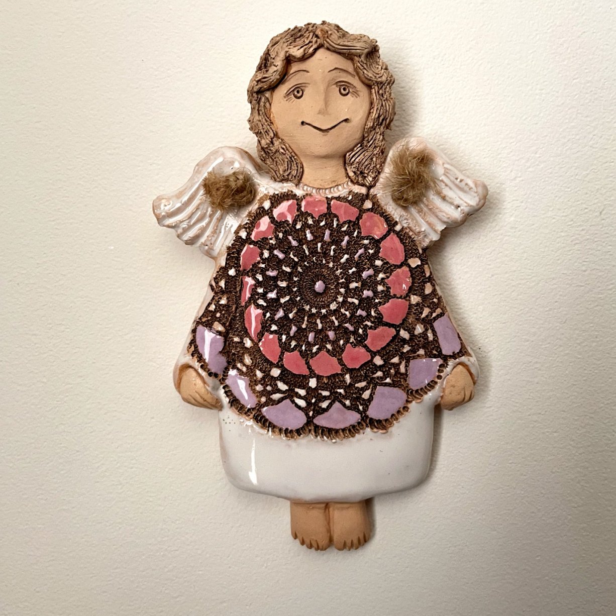 ceramic wall angel with decorative patterned dress