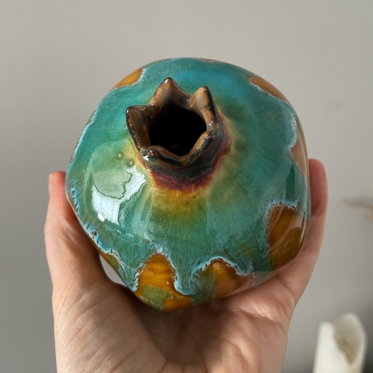 Handmade pottery pomegranate vase used as small flower holder