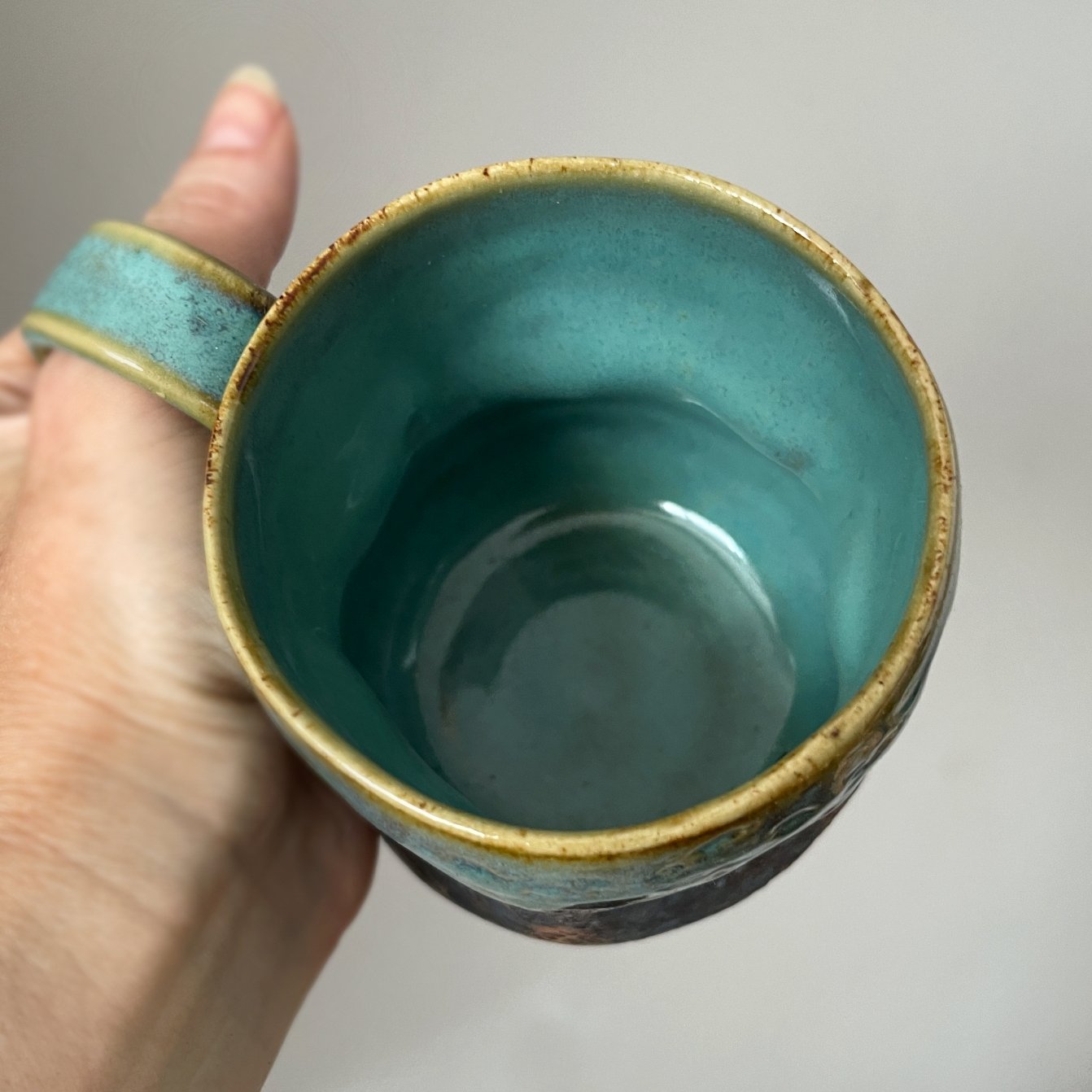Top view of ceramic mug with turquoise glazed interior