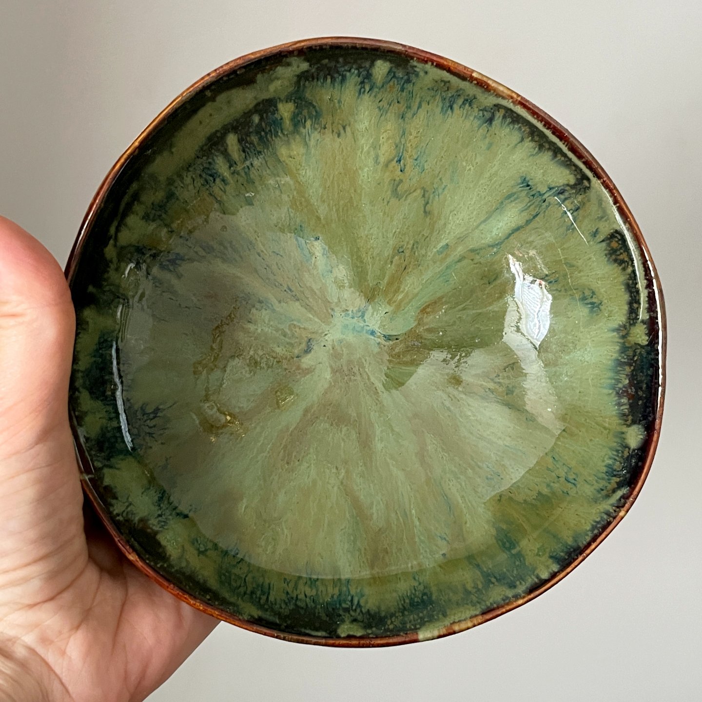 Large handmade ceramic bowl with green glazed interior
