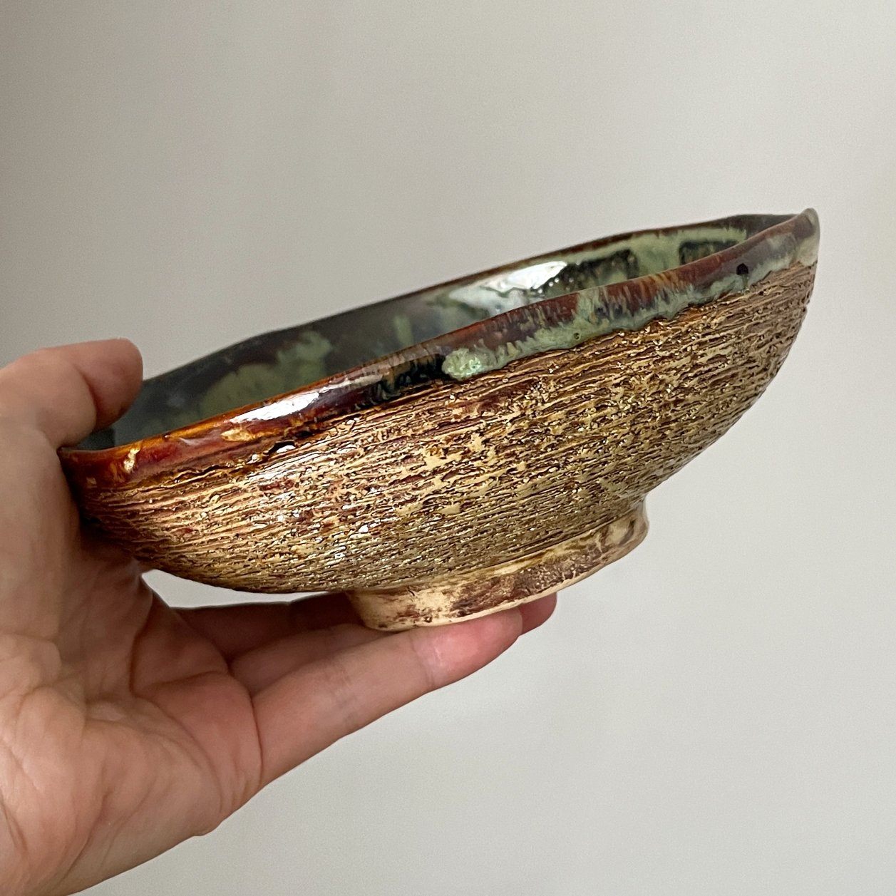 Side view of handmade ceramic soup bowl with textured exterior